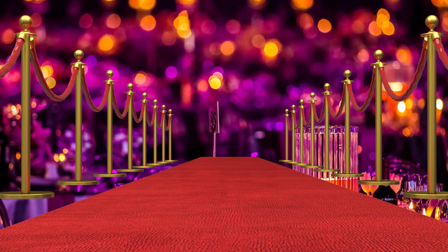 A red carpet bounded by gold coloured stanchions.