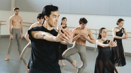 A choreographer showing arm movements to dancers