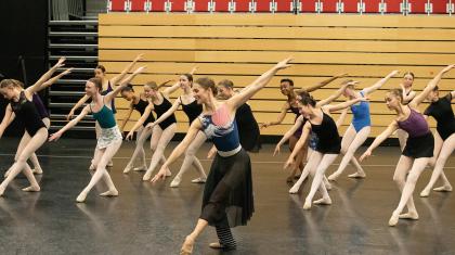 Charlotte Tonkinson in a ballet pose with academy students