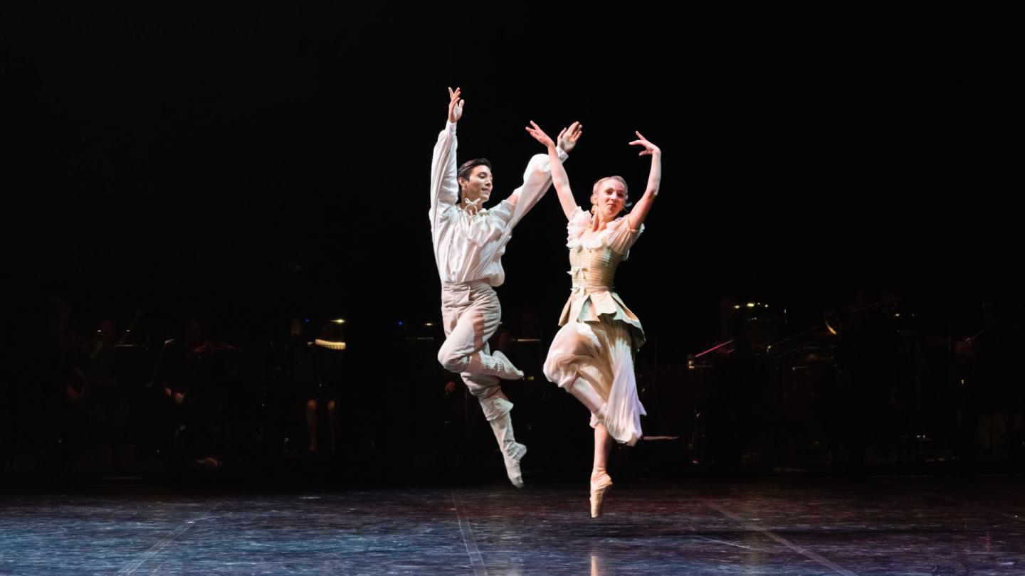 Two dancers leap in the air in a scene from The Three Musketeers
