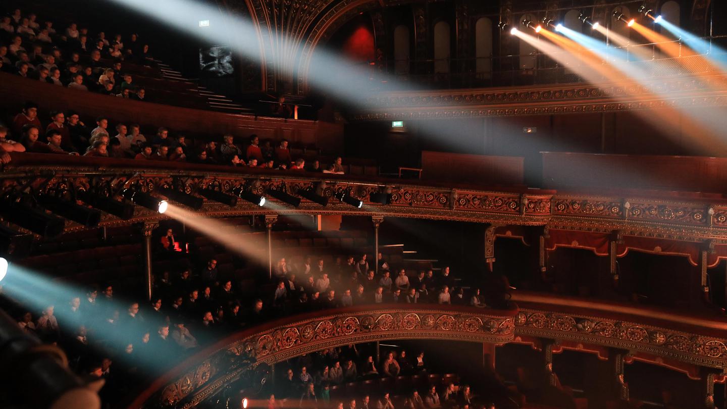 The auditorium at the Leeds Grand Theatre during a school's matinee performances. The theatre is packed with students.