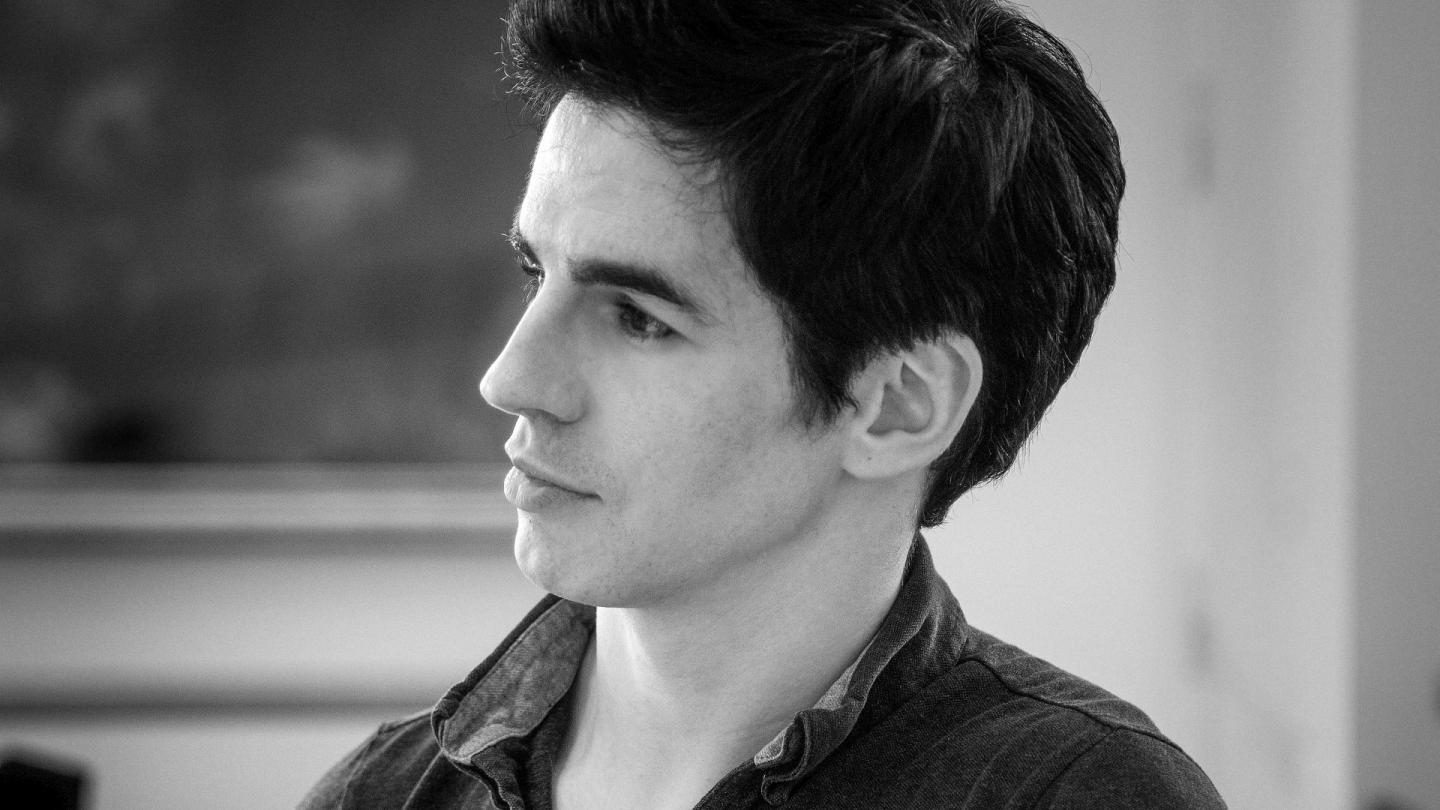 Black and white headshot of Federico Bonelli, looking away from the camera.