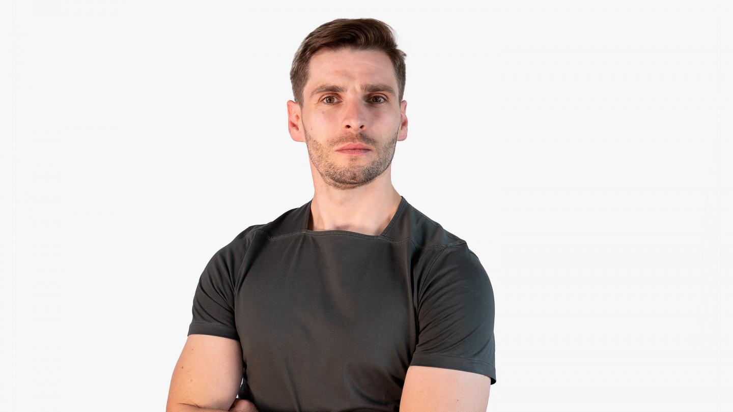 Headshot of a male dancer in a dark t-shirt