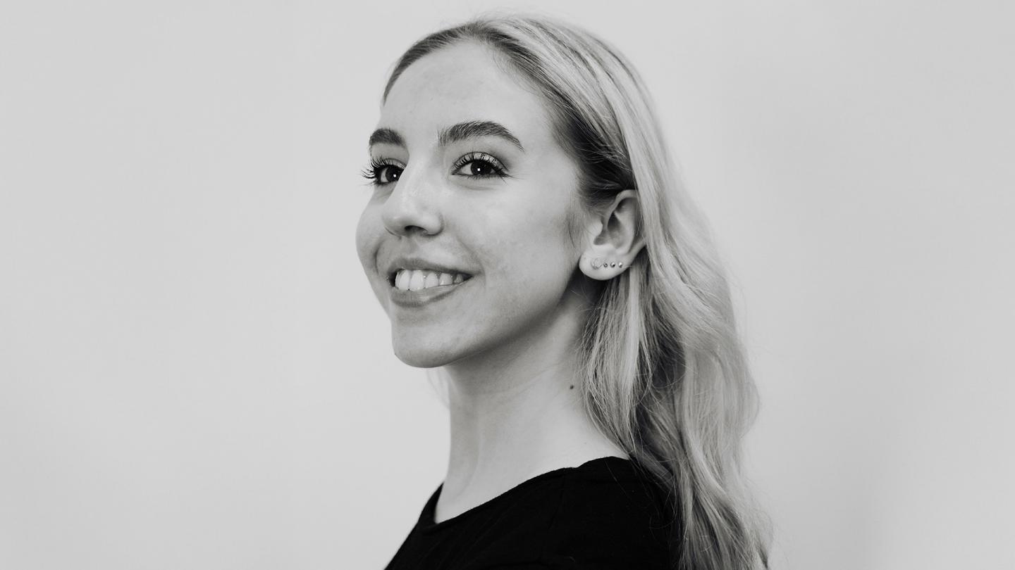 Black & White photo of a blonde woman in a black jumper