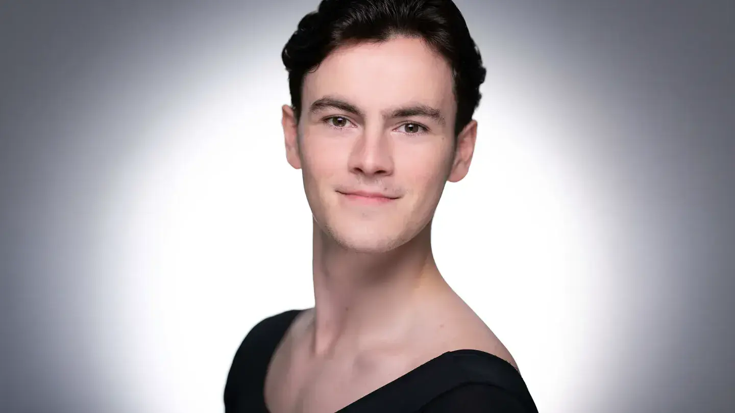 Man with short dark hair looks straight at the camera