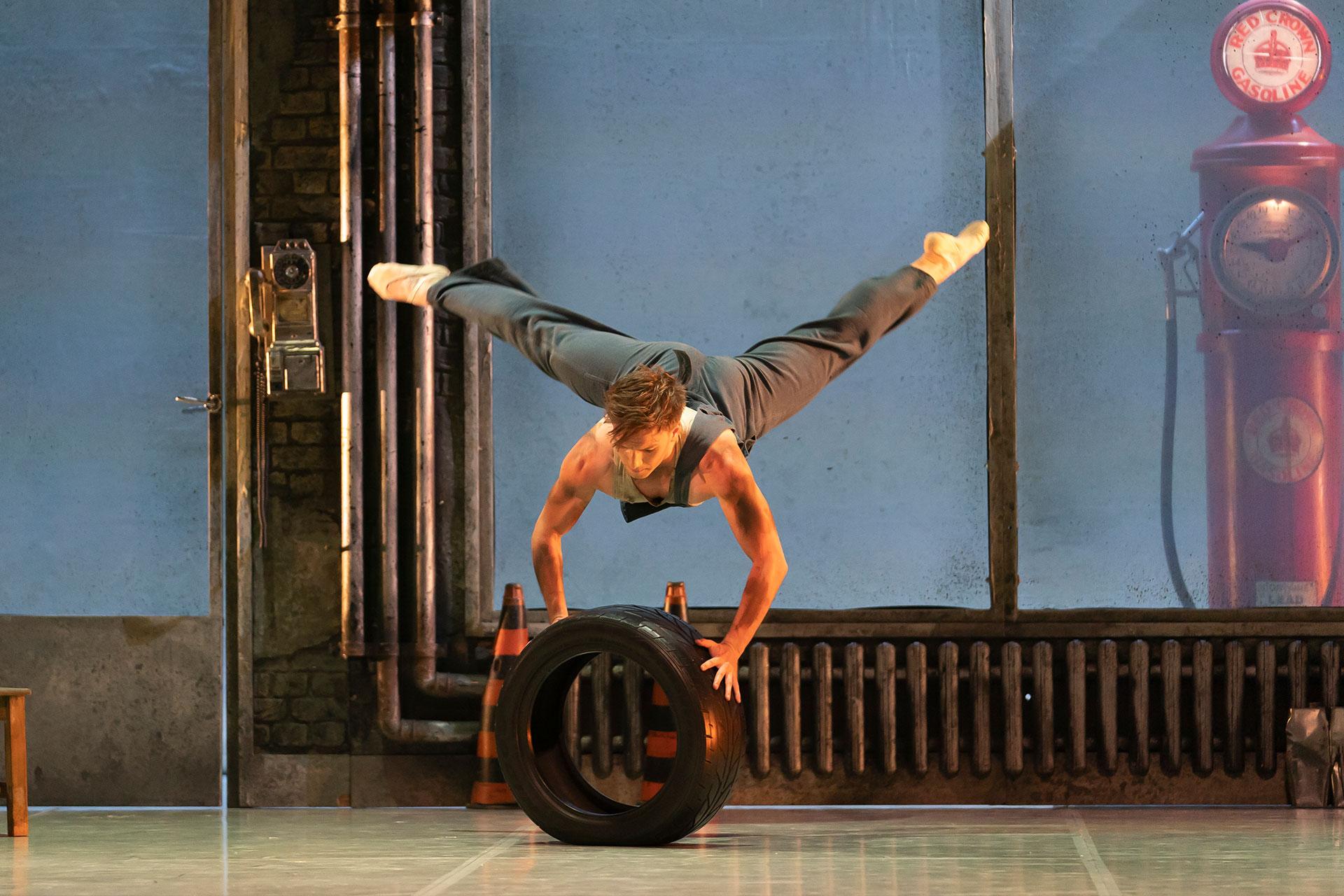 Matthew Topliss as George dancing with a tyre in his garage in The Great Gatsby. Photo Emma Kauldhar.