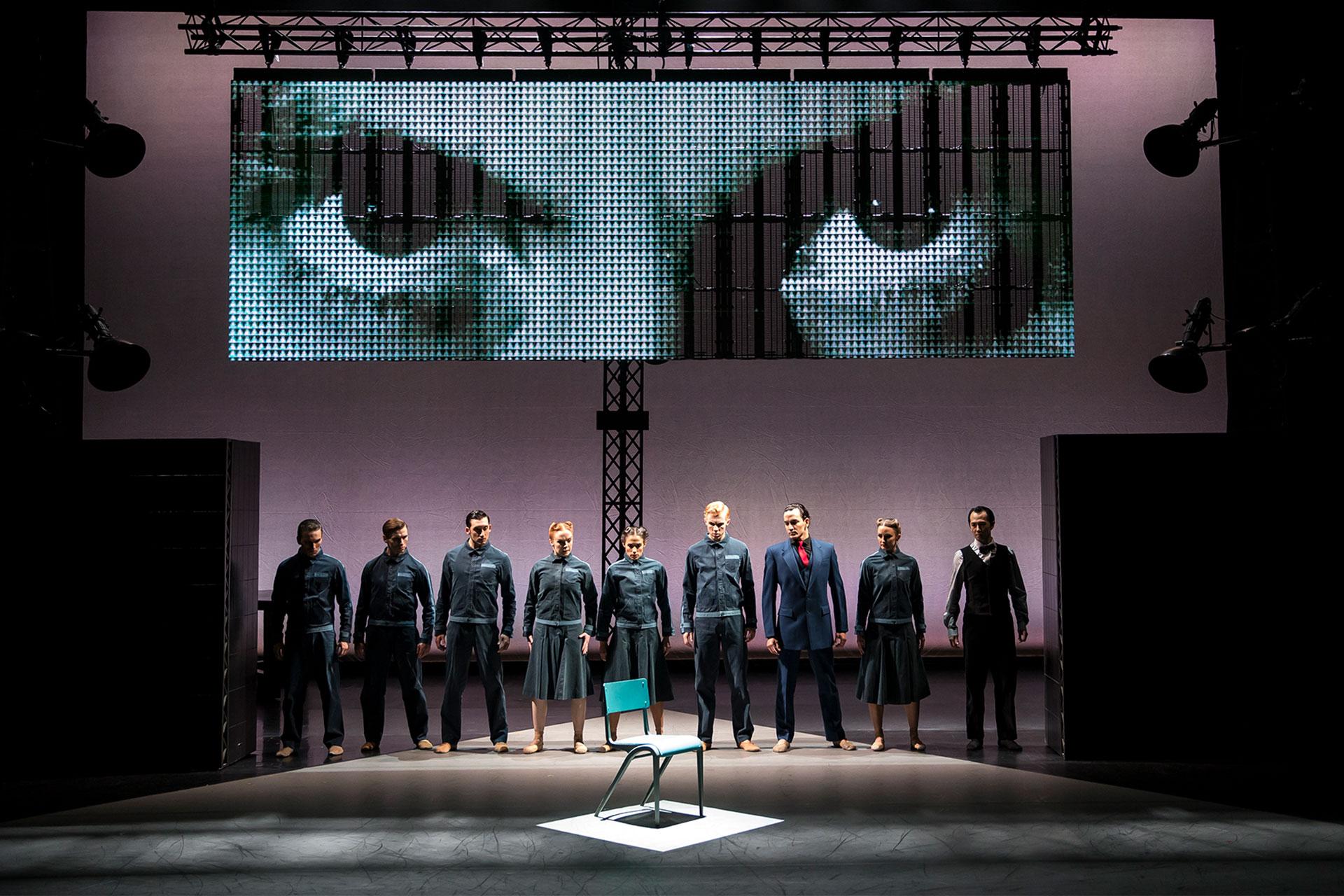 1984, production, 2015, Northern Ballet dancers, photo Emma Kauldhar Members of the party look at the chair when the non-person, Winston Smith, never sat