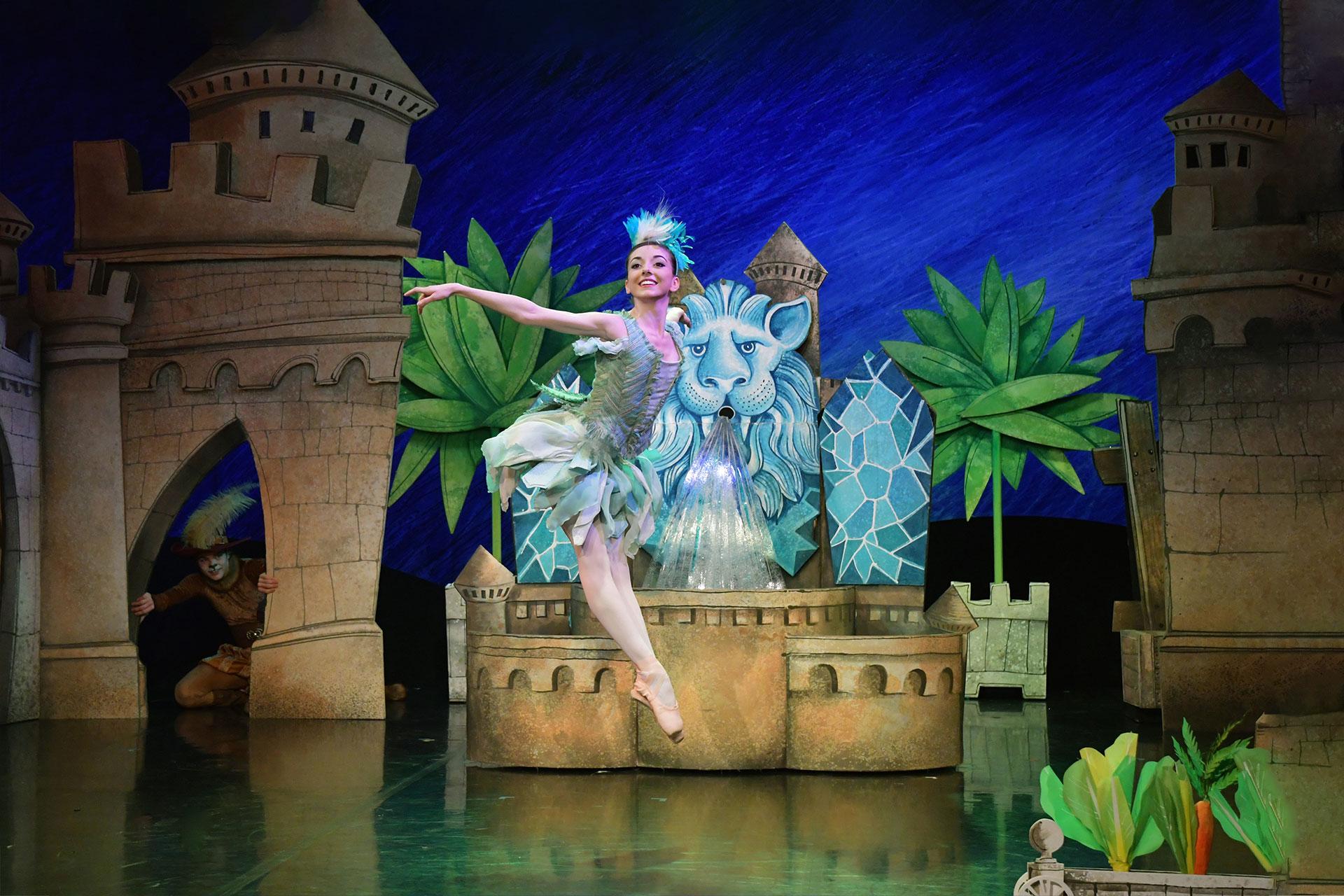 Puss in Boots, 2018, Ayça Anil as Little Bird, photo Brian Slater Little Bird flits in front of the fountain