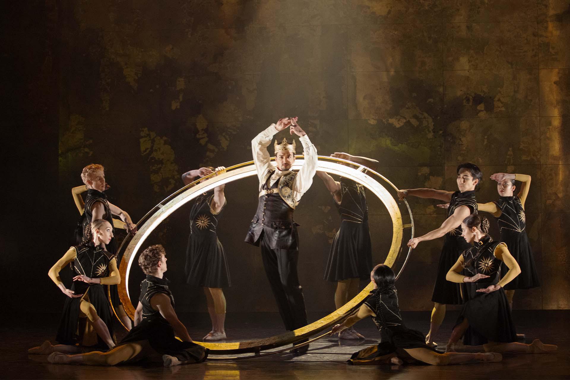 Vortigern proudly stands at the centre of the circle, arms clasped above his head