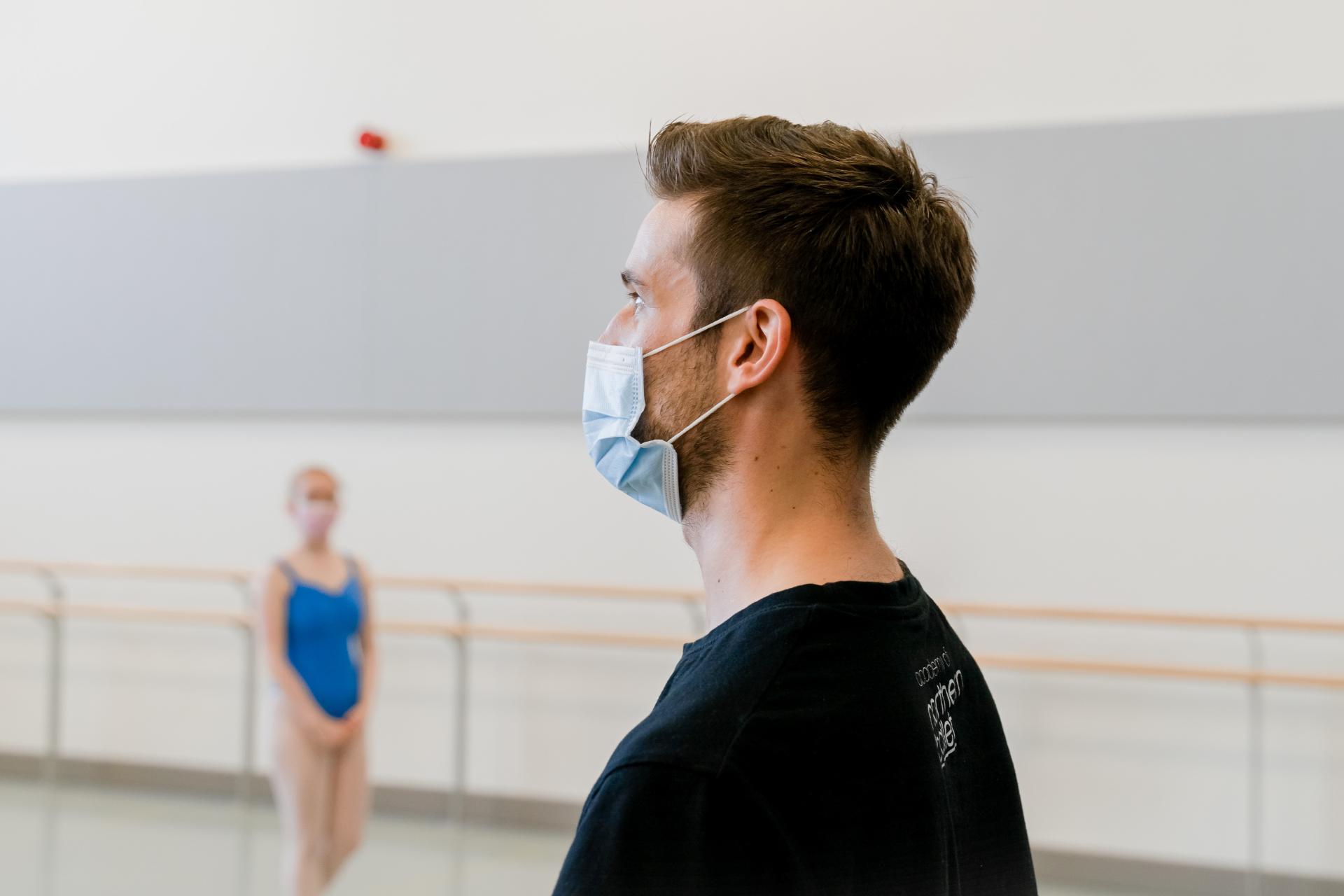 A male dance teacher wearing a face mask