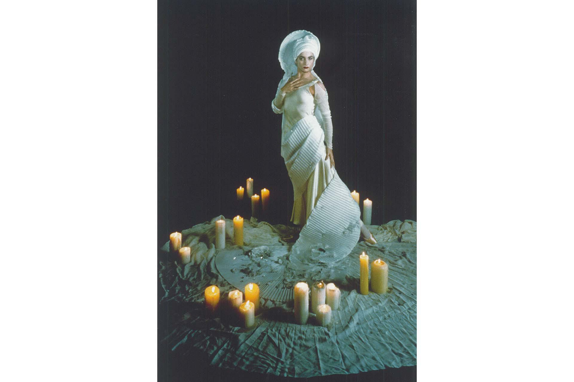 Great Expectations’ Miss Havisham standing in her white wedding dress surrounded by lit candles