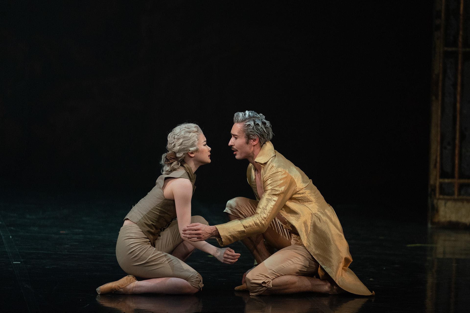 Casanova dressed in a golden coat looks into lovingly the eyes of Henriette