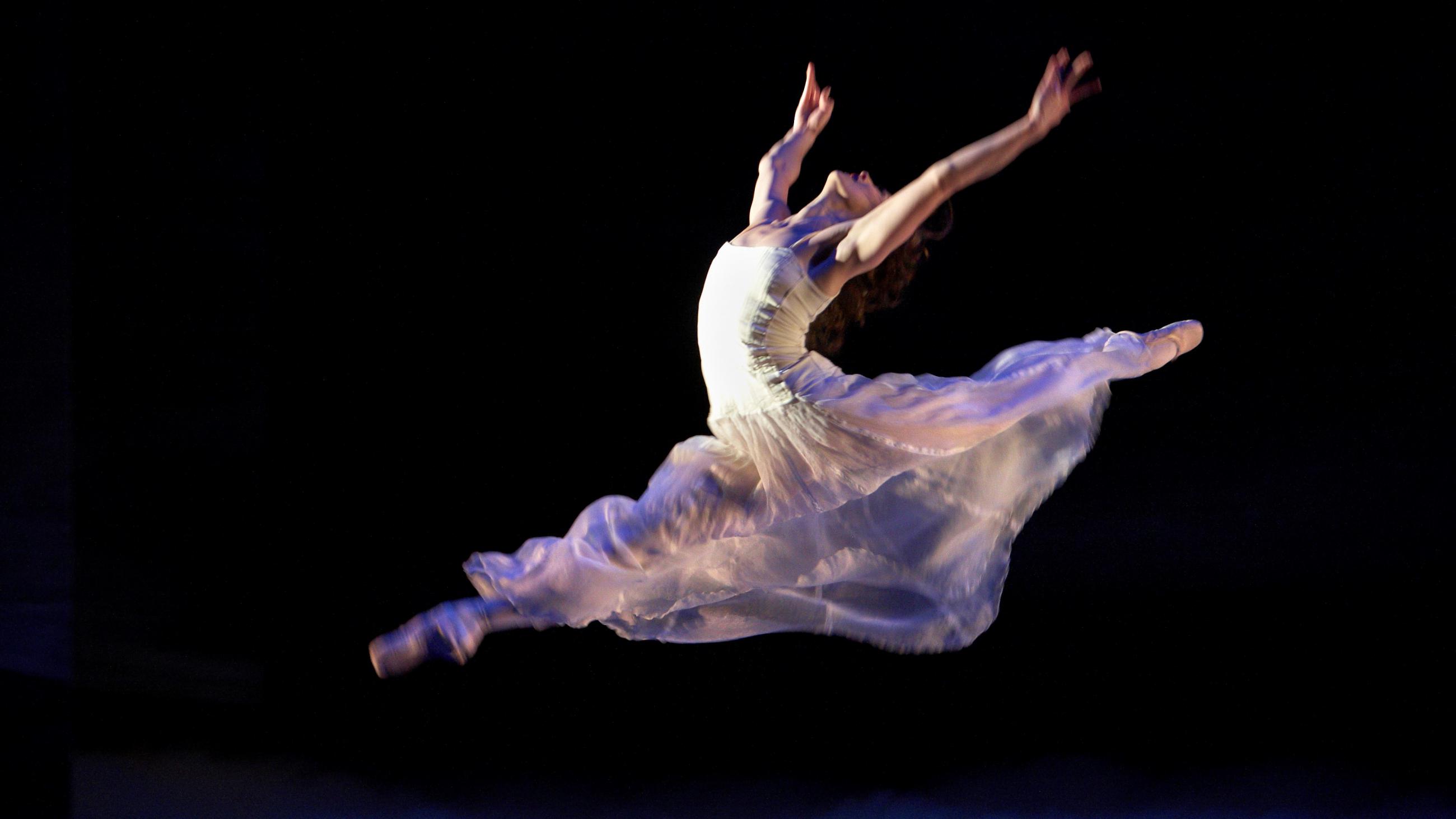A photo of Northern Ballet dancer Georgina May leaping through the air as Cathy in David Nixon OBE's Wuthering Heights. Photo by Merlin Hendy, 2009.