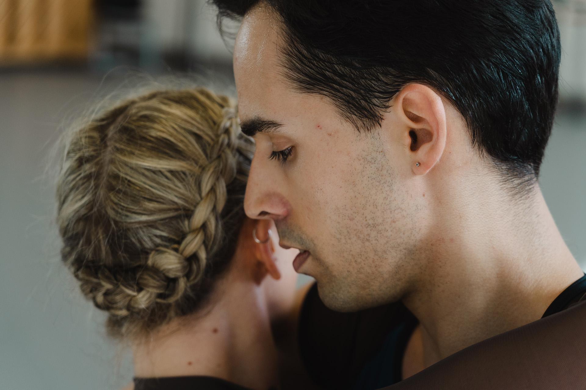 Close up of face of dancer Harry Skoupasas his holds dancer Harriet Marden closely