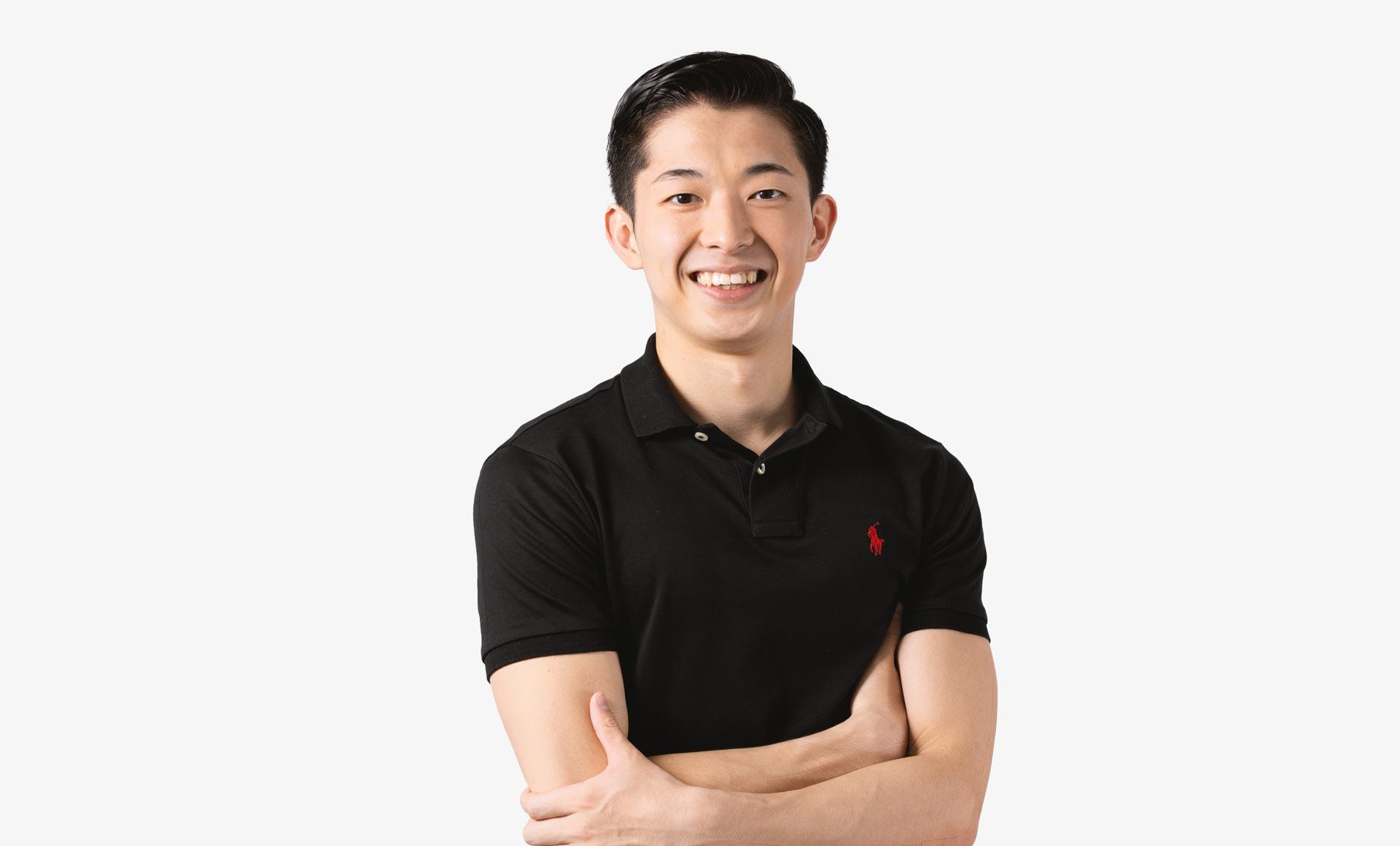 A headshot of a man looking forward in a black polo shirt