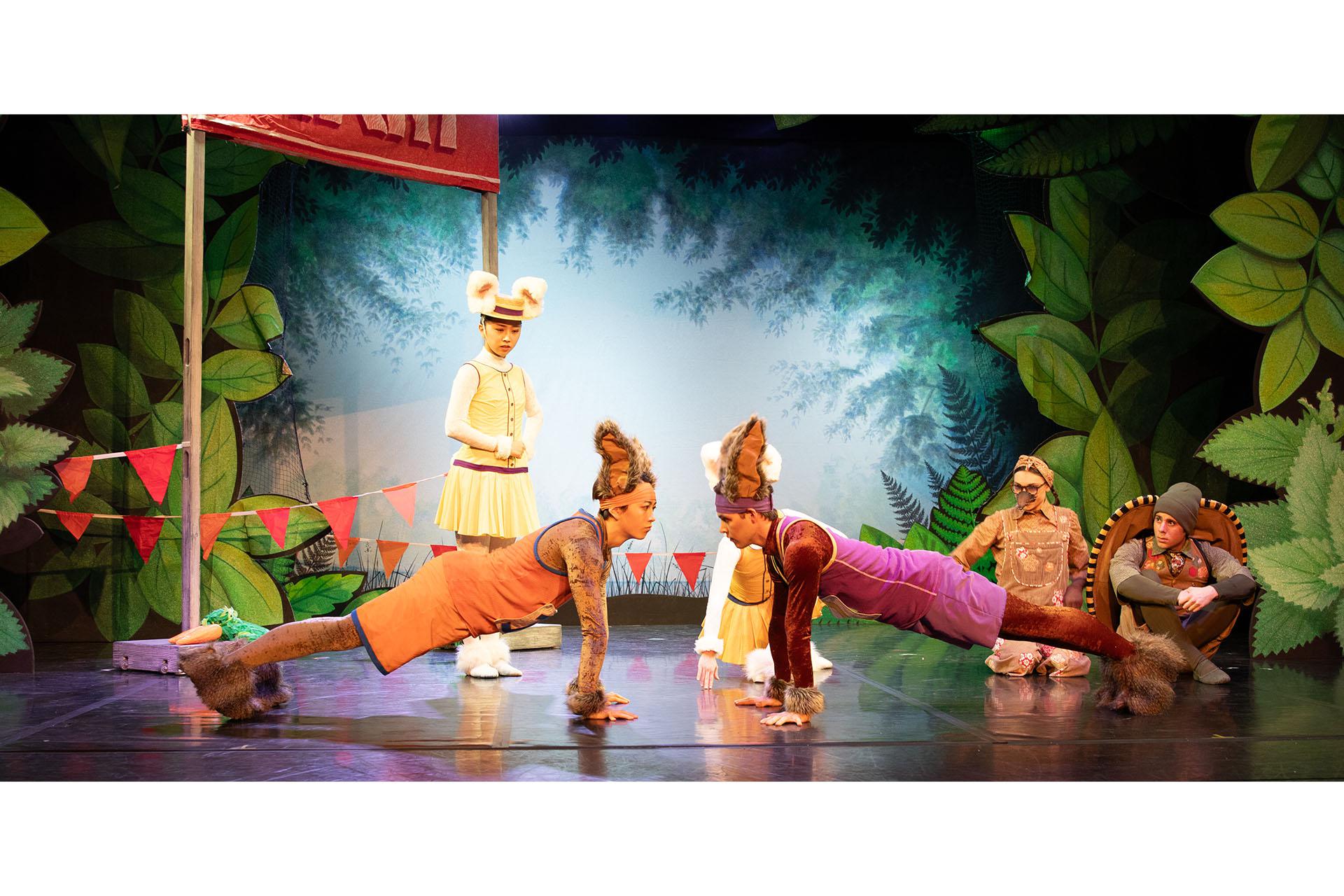 Tortoise & the Hare, production, 2024, Northern Ballet dancers. Photo Sophie Beth Jones Dancers in bunny costumes, preparing for the race facing each other in a plank position