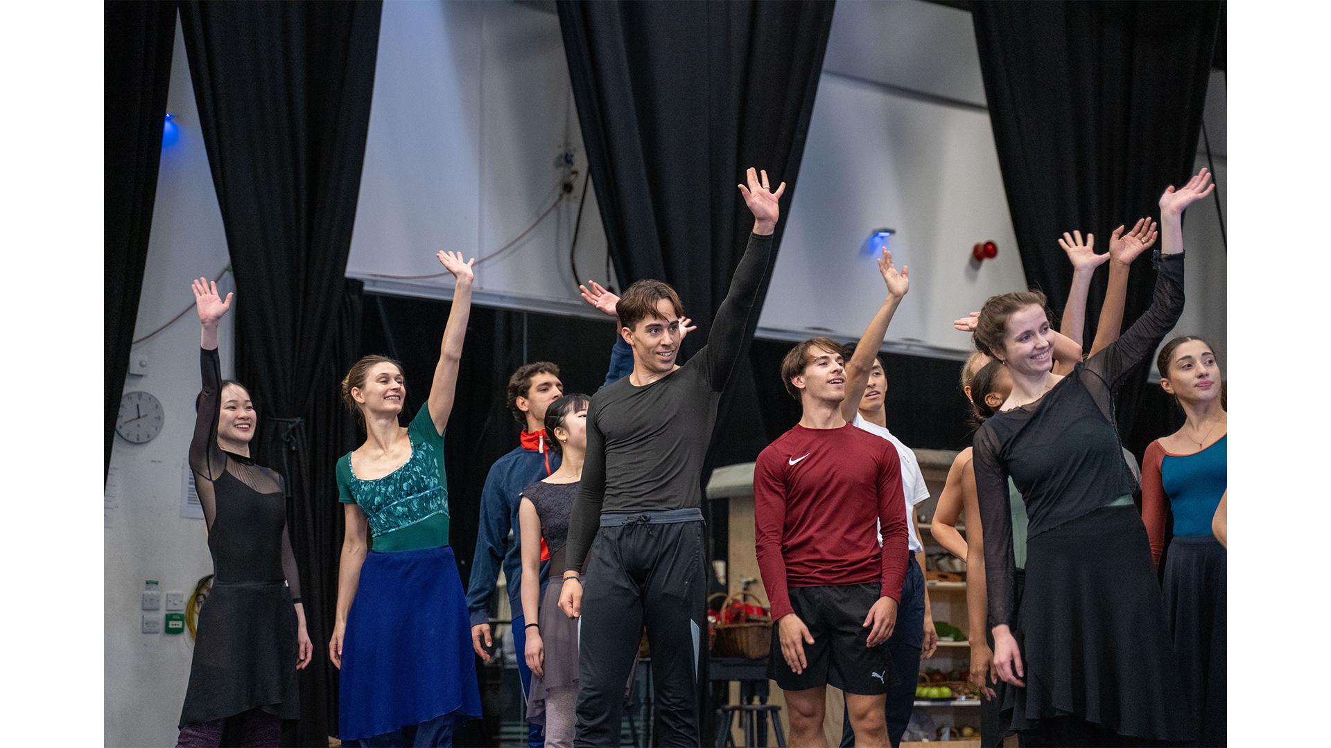 A group of dancer waving in rehearsal