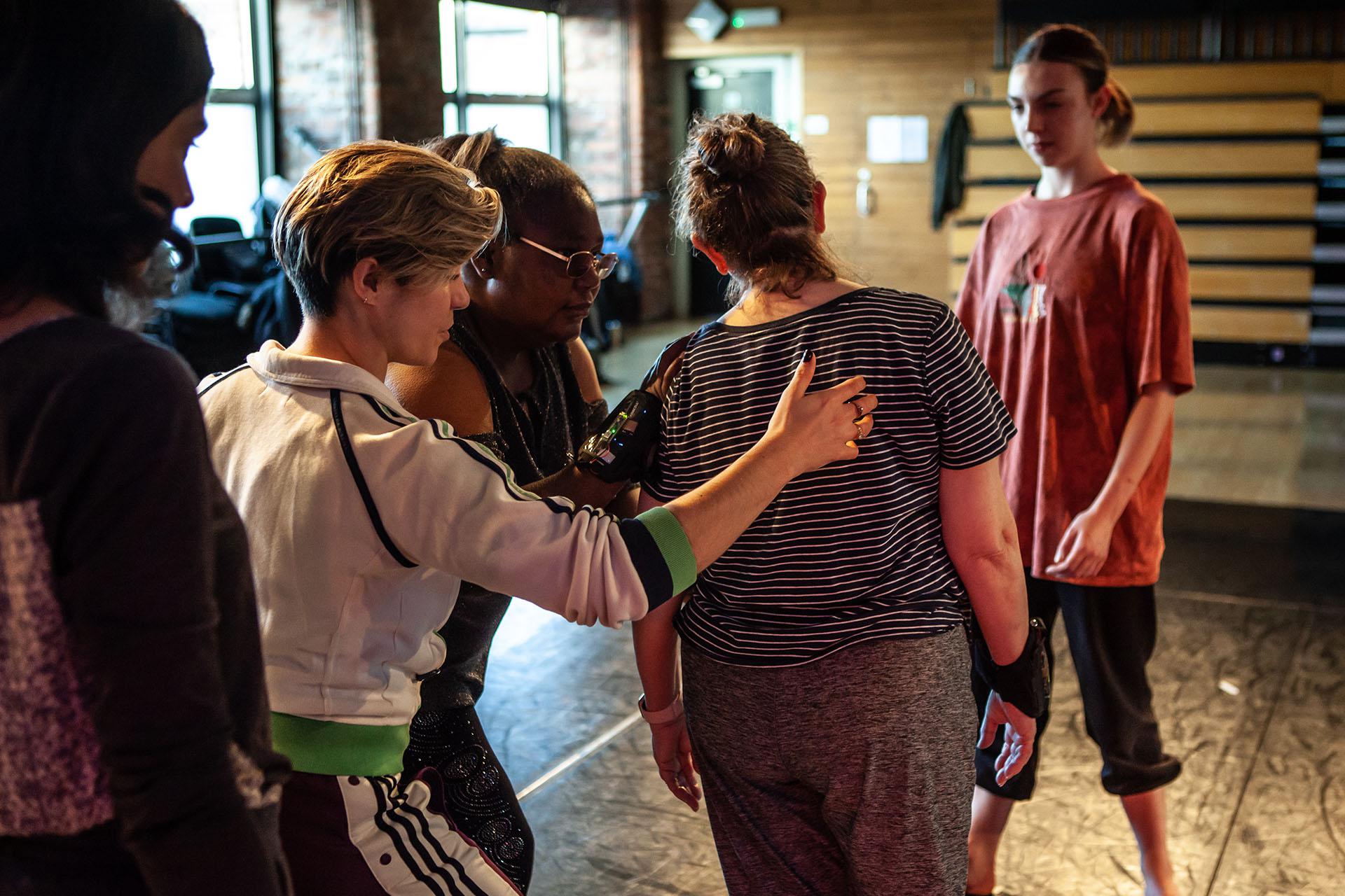 Group rehearsing and practicing while physically supporting each other