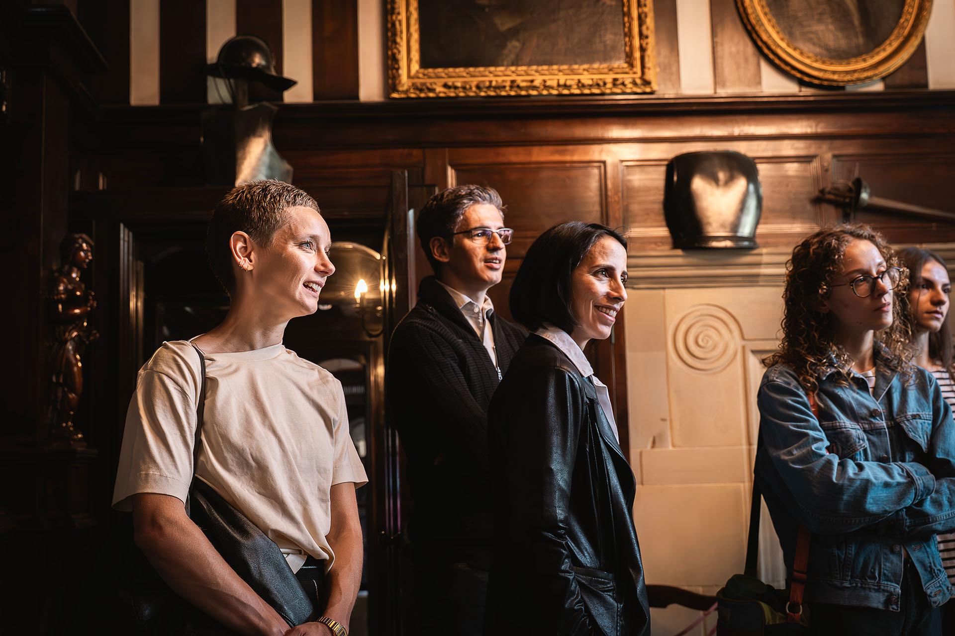 Louise Flanagan, Federico Bonelli and Annabelle Lopez Ochoa stood in the lobby of Shibden Hall, listening in tently to an unseen person enchanting people with the history of the home of Anne Lister.