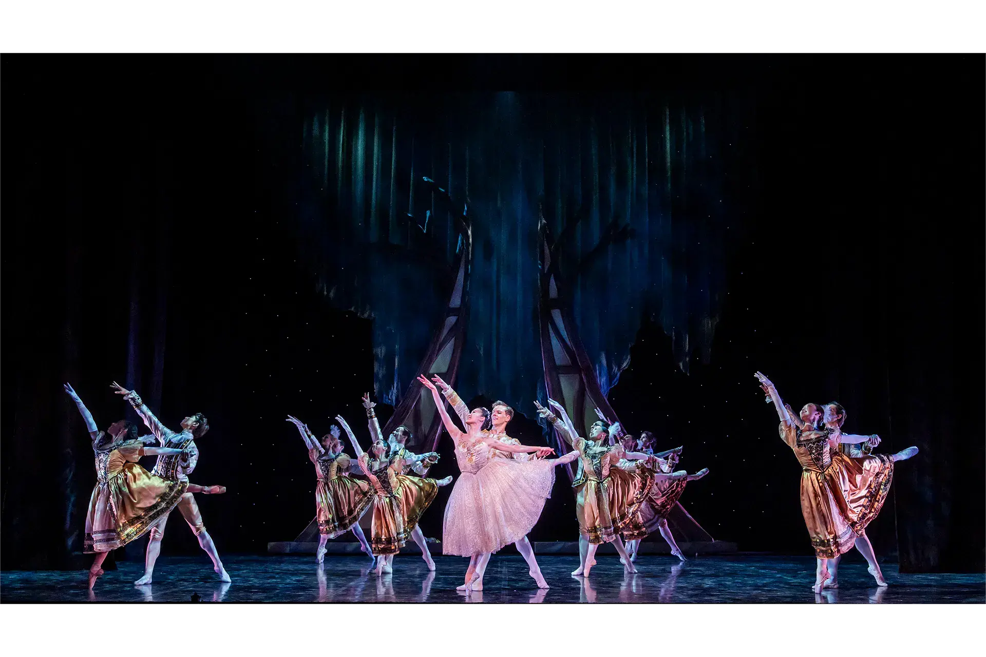 The group all in unison dancing at the final ball, in front the Prince and Cinderella