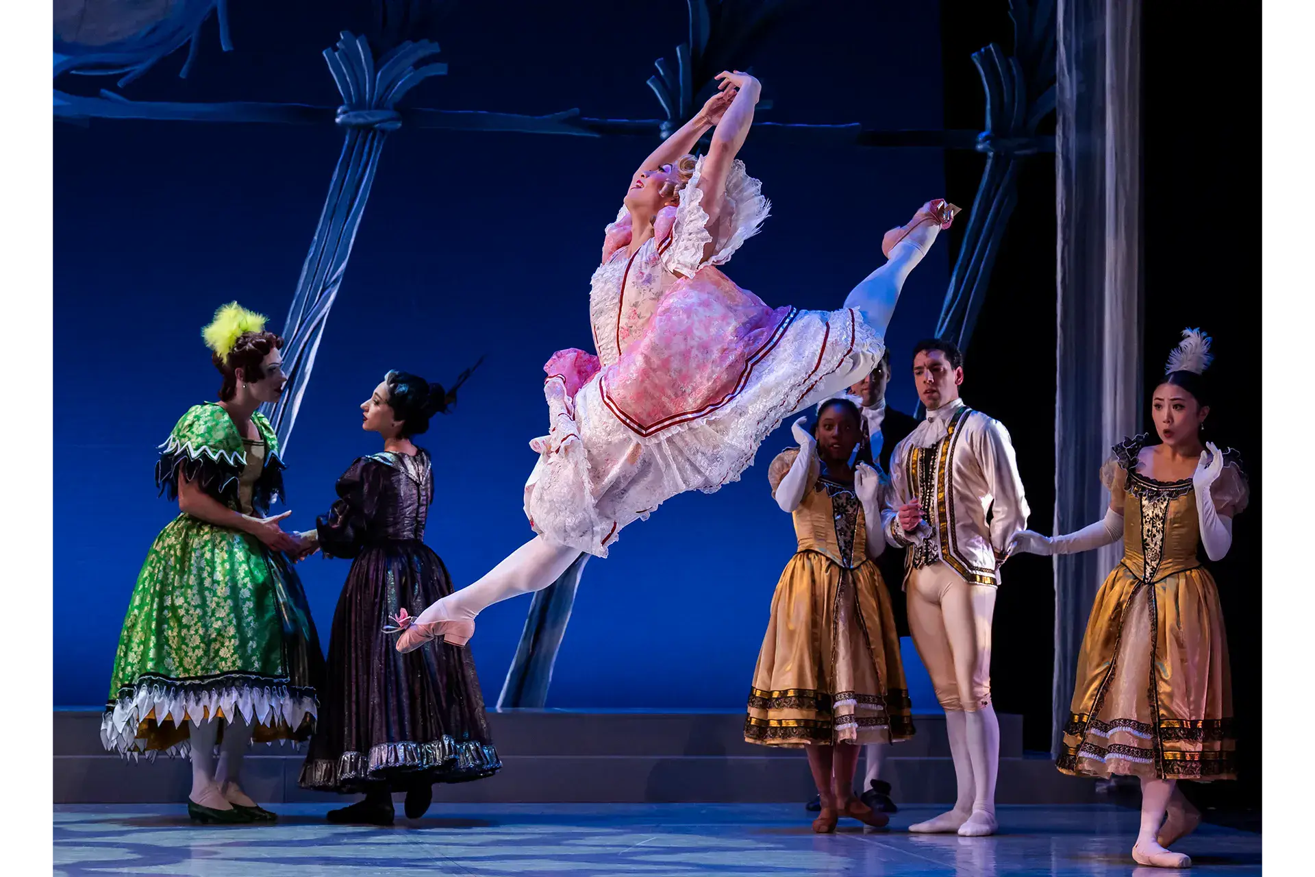 Leaping, a step-sister in a chocolate-box dress and wearing garish make-up