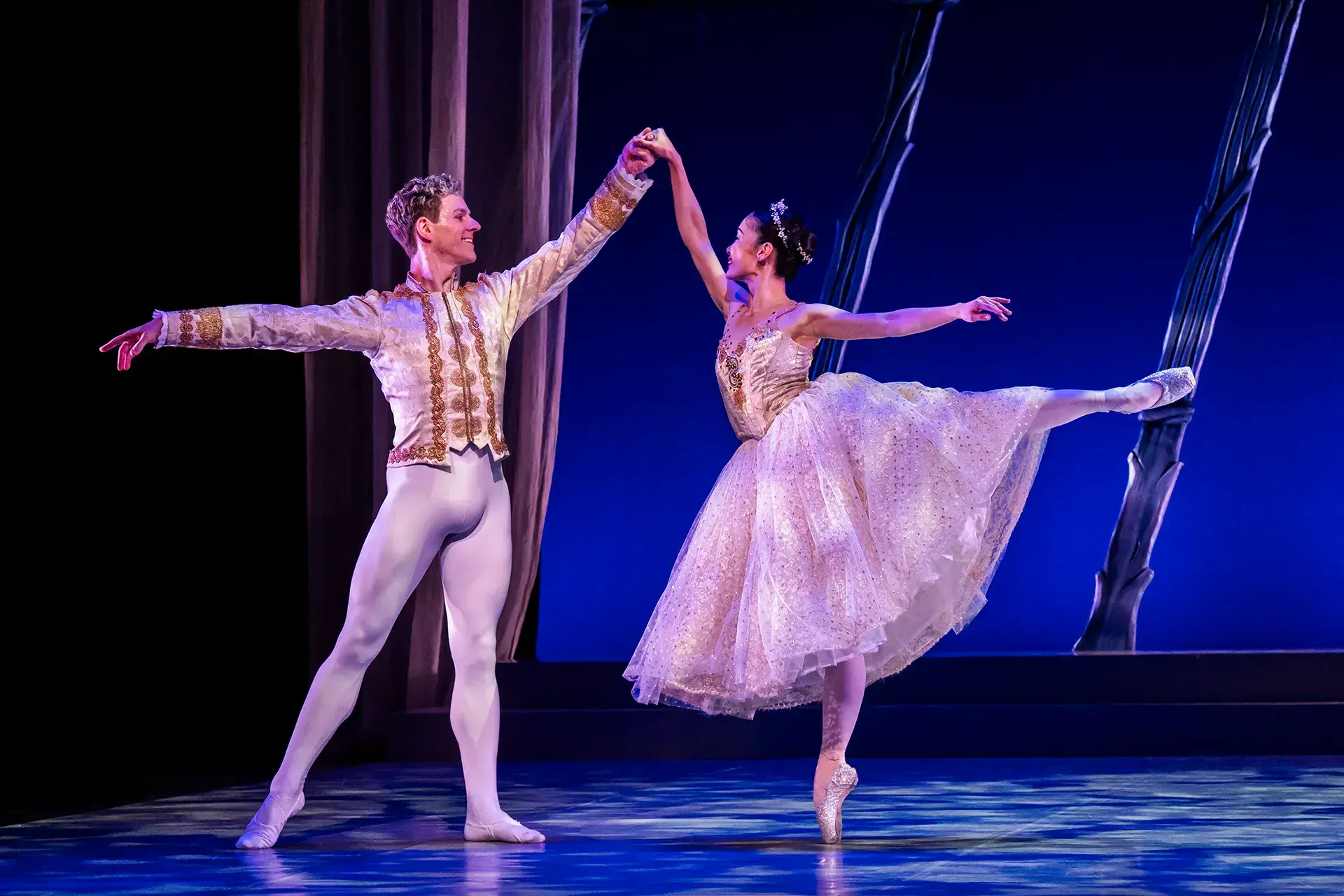 In their shimmering finery, the Prince and Cinderella dance elegantly