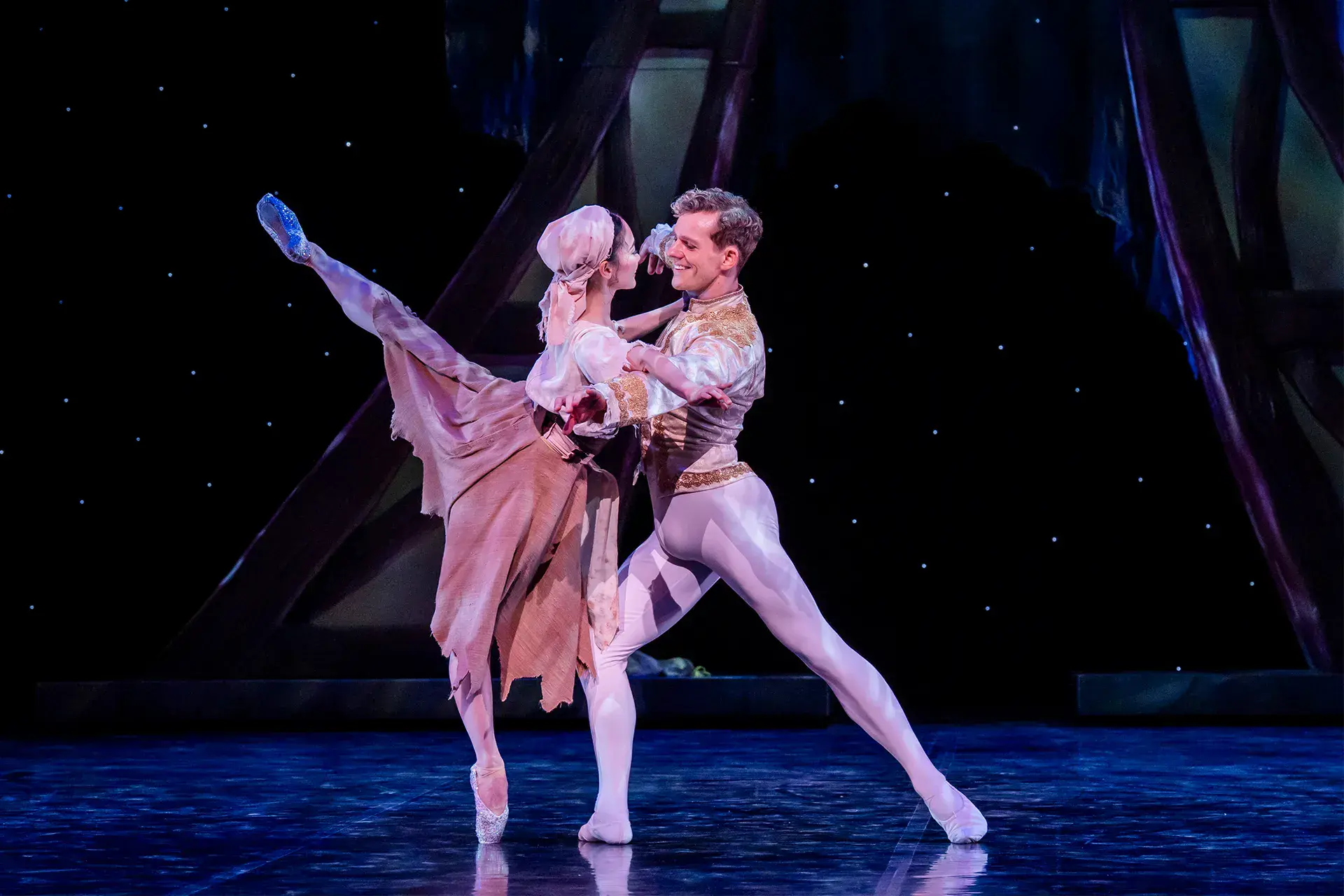 The Prince in his finery dancers closely with Cinderella in her rags, but she has poise and grace as she holds him and stands arabesque en pointe