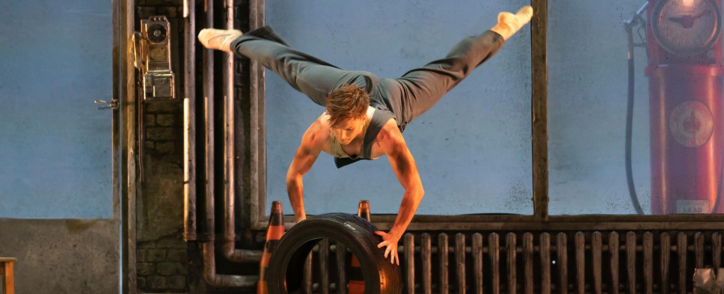 Matthew Topliss as George dancing with a tyre in his garage in The Great Gatsby. Photo Emma Kauldhar.