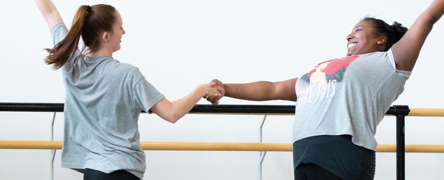 Two people dancing holding hands