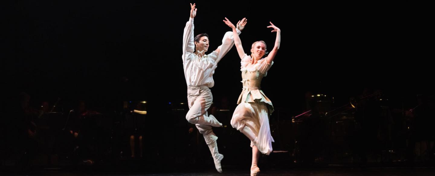 Two dancers leap in the air in a scene from The Three Musketeers