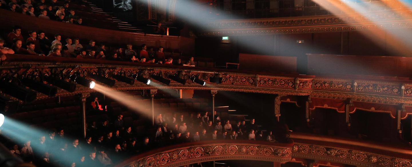 The auditorium at the Leeds Grand Theatre during a school's matinee performances. The theatre is packed with students.