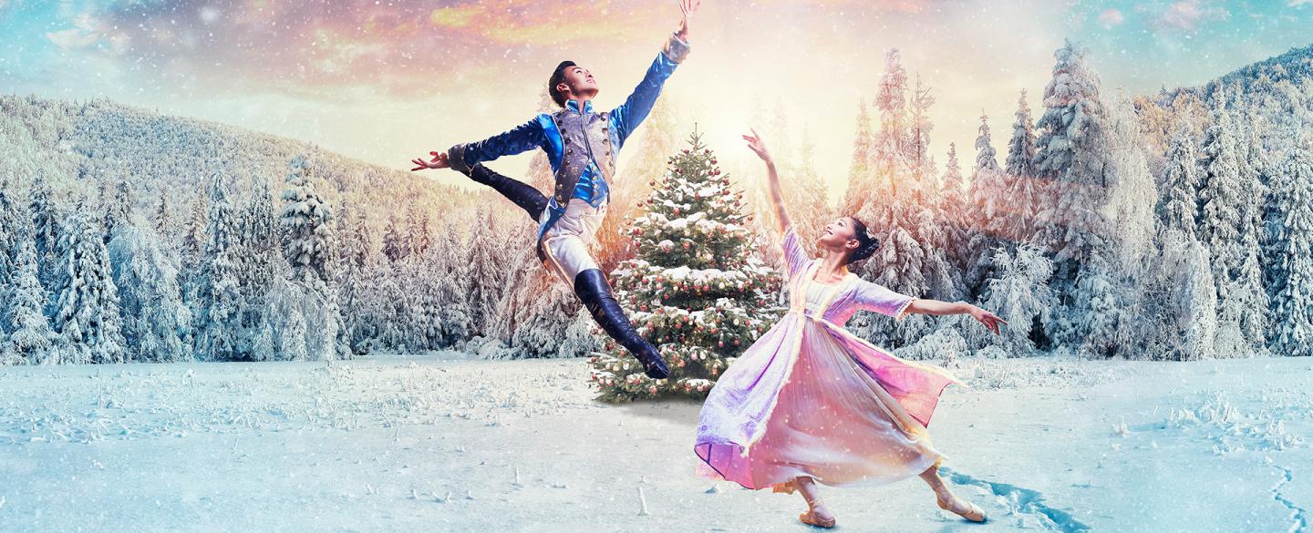 The Prince and Clara dancing in front of a Christmas tree