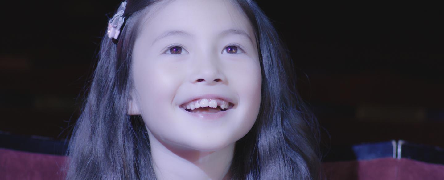 Young girl smiles at the magic in front of her