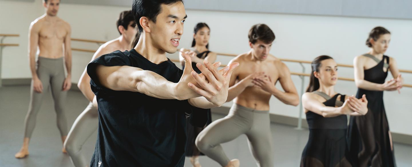 A choreographer showing arm movements to dancers