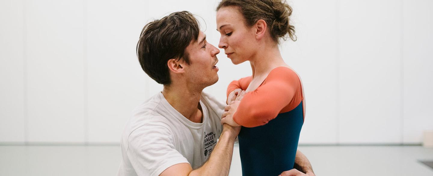 Two dancers in rehearsal look lovingly at each other as their roles of Prince Albert and Queen Victoria