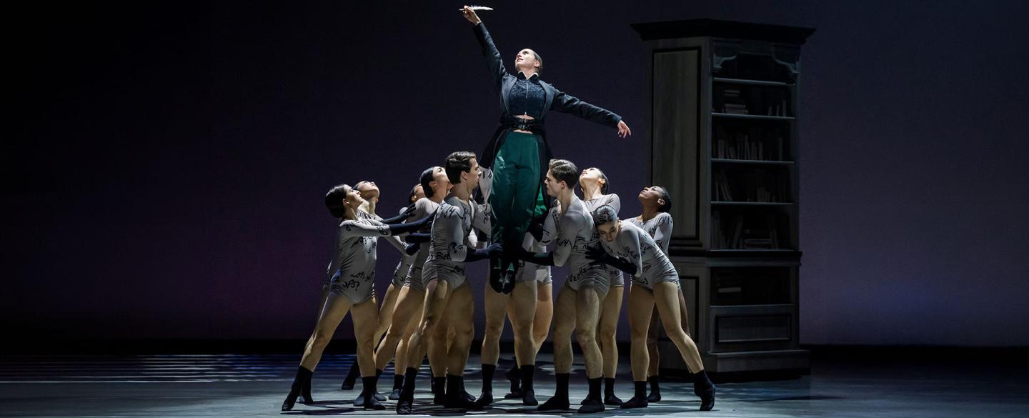 Anne Lister lifted by her words (represented by eleven dancers) and in turn raising a quill