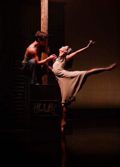 In the glow of a streetlight, two dancers dressed plainly show their love through dance
