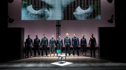 Members of the party look at the chair when the non-person, Winston Smith, never sat