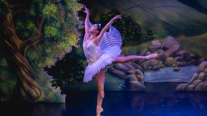A dancer in a tutu in an arabesque