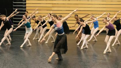 Charlotte Tonkinson in a ballet pose with academy students