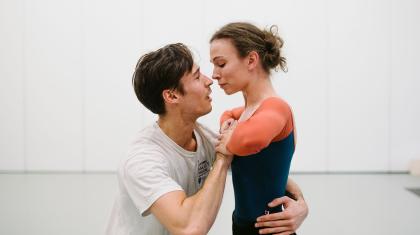 Two dancers in rehearsal look lovingly at each other as their roles of Prince Albert and Queen Victoria