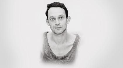 Monochrome image of male dancer with light skin and short dark hair