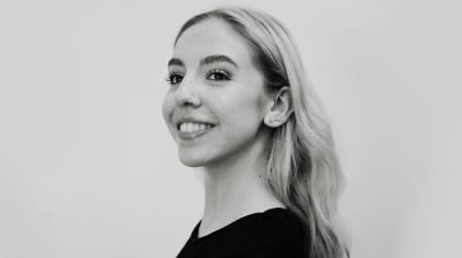 Black & White photo of a blonde woman in a black jumper