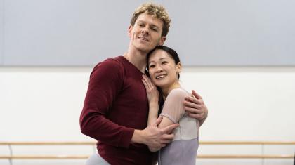 Two dancers hold each other lovingly and smile