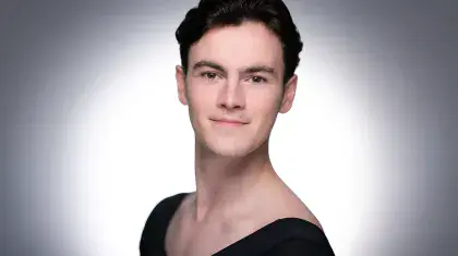 Man with short dark hair looks straight at the camera
