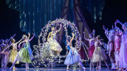 Cinderella waves from her crystal carriage at the crown of beautiful guests